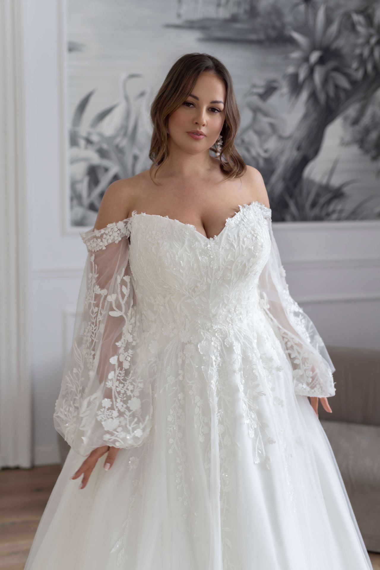 Curvy A-Linien-Brautkleid mit Off-Shoulder-Ausschnitt, Puffärmeln, floraler Spitze und Tüllrock – Weddingdress bei Brautfashion in Sins
